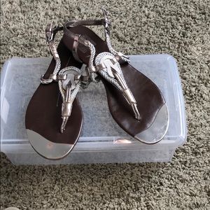 Silver thong Sandals with silver playing on toes.